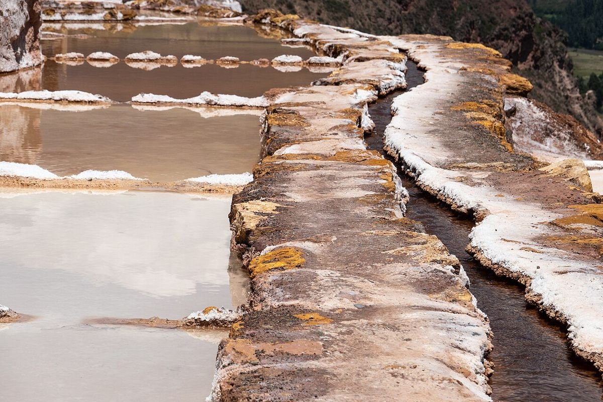 Salt water running along a narrow channel between the pools