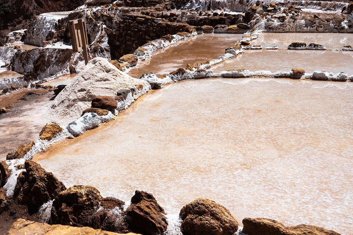 A shallow pool with a crust of salt forming at its edges