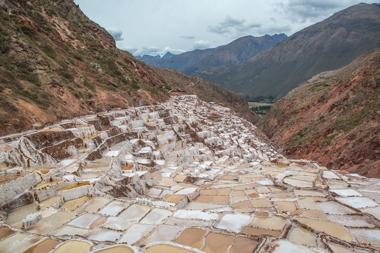 The salt terraces of Maras under a cloudy Andean sky